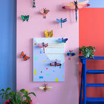 mounted on a purple wall with a red chair