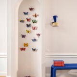 Studio ROOF butterfly 3D cardboard wall art decorations displayed on a wall, including the Crysalus Butterfly, colourful recycled cardboard butterflies assembled as decorative wall art.