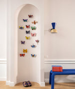 Studio ROOF butterfly 3D cardboard wall art decorations displayed on a wall, including the Crysalus Butterfly, colourful recycled cardboard butterflies assembled as decorative wall art.