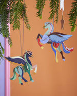 2 Studio Roof DIY card Pegasus Christmas tree decorations hanging in front of an orange background