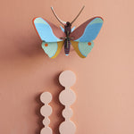 Studio Roof Claudina Butterfly decoration pictured on a peach coloured  painted wall