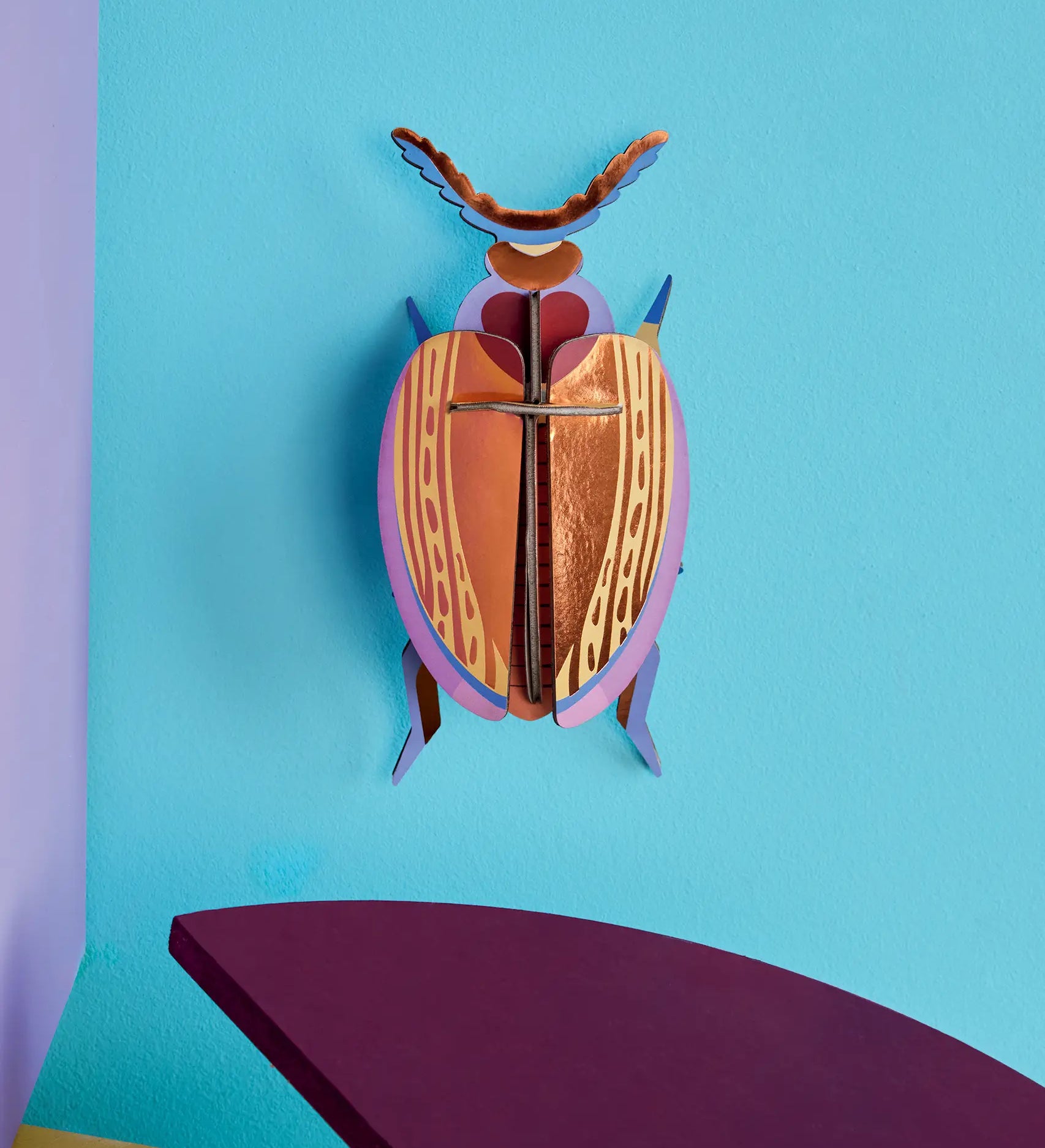 Studio Roof 3D cardboard Cuprum beetle craft kit displayed on a wall 
