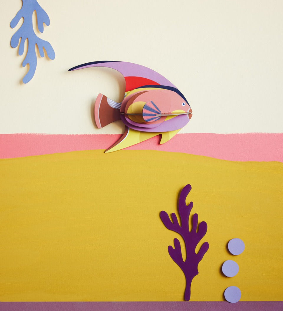 Studio Roof card craft fish on a pink and yellow wall next to some card plants
