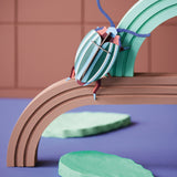 Studio roof eco-friendly cardboard rainbow lead slotting model bug climbing on a green and brown arch above some model leaves
