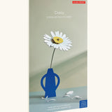 Studio Roof daisy everlasting flower cardboard flower decoration shown in it's packaging.