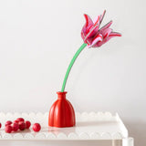 Studio Roof pink tulip everlasting flower cardboard decoration shown built and displayed in a red jar. 
