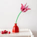 Studio Roof pink tulip everlasting flower cardboard decoration shown built and displayed in a red jar. 