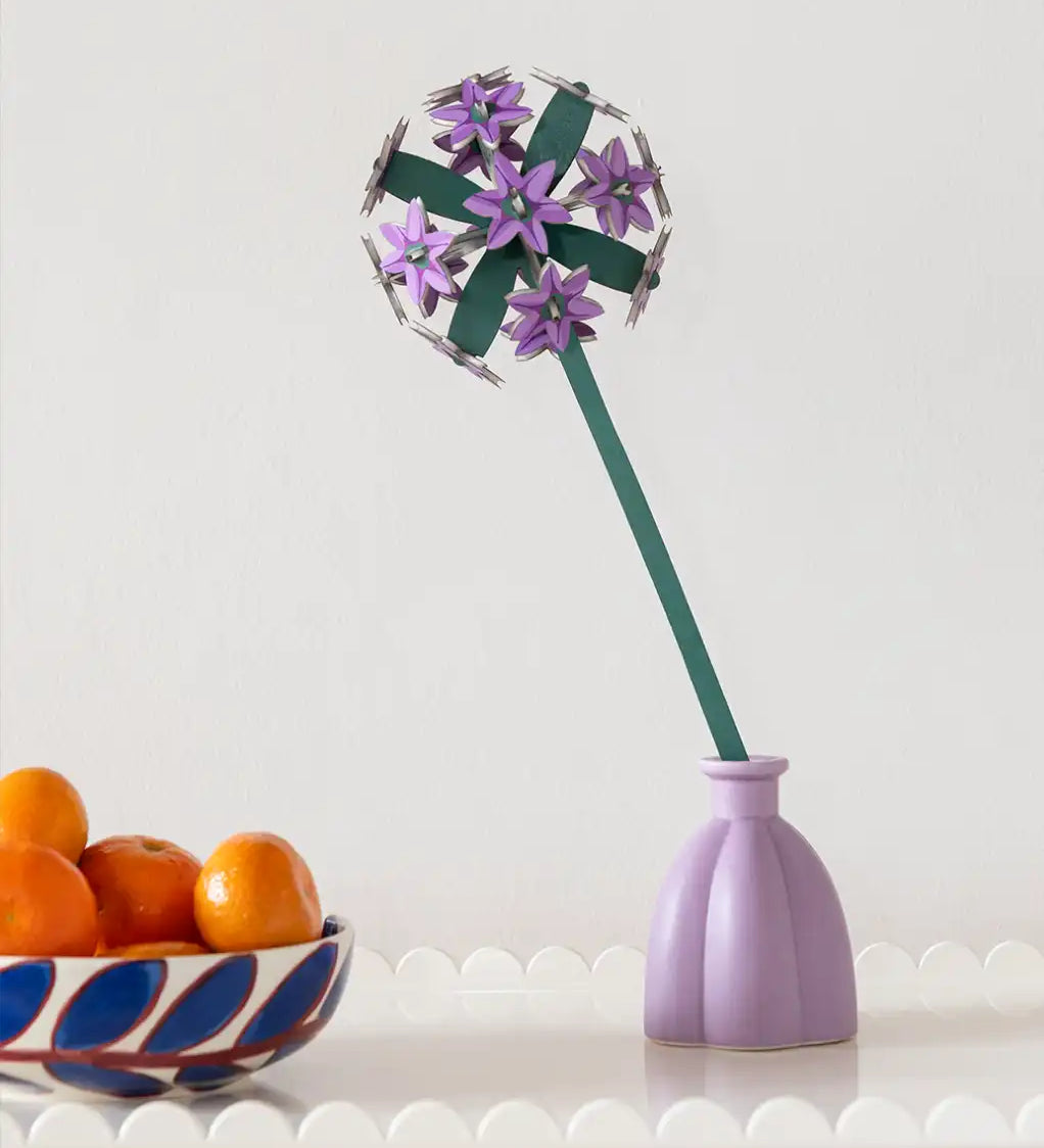 Studio Roof allium everlasting flower decoration craft kit shown built and placed in a purple vase.