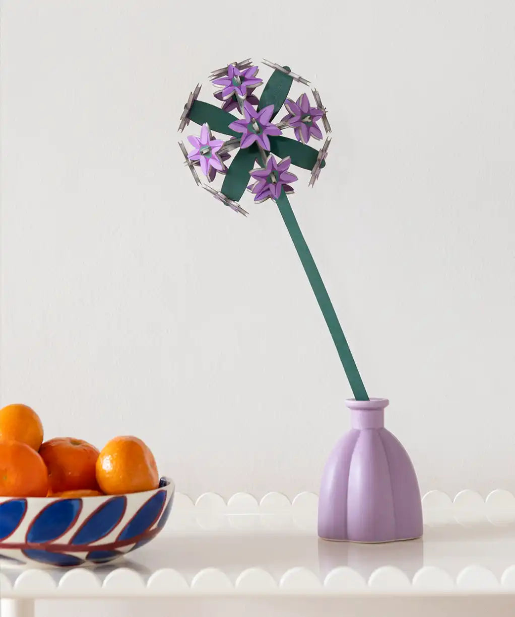 Studio Roof allium everlasting flower decoration craft kit shown built and placed in a purple vase.