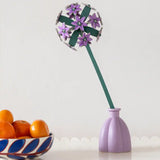 Studio Roof allium everlasting flower decoration craft kit shown built and placed in a purple vase.