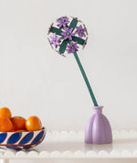 Studio Roof allium everlasting flower decoration craft kit shown built and placed in a purple vase.