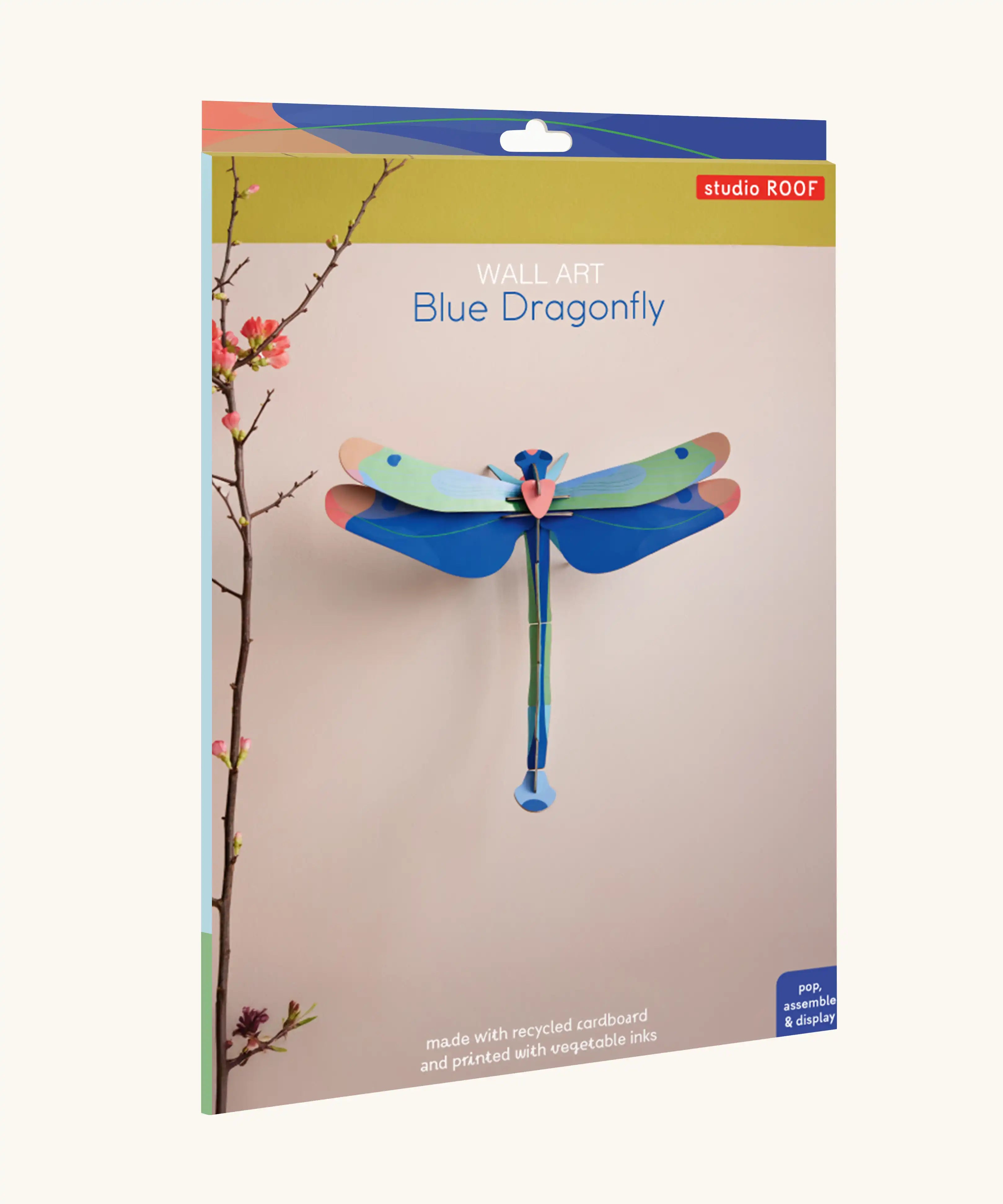 Studio Roof Blue Dragonfly Cardboard Wall Art shown in it's packaging.