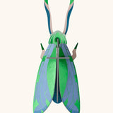 A Studio Roof 3D jade graasshopper cardboard wall art fully assembled with a metallic finish on the pieces.