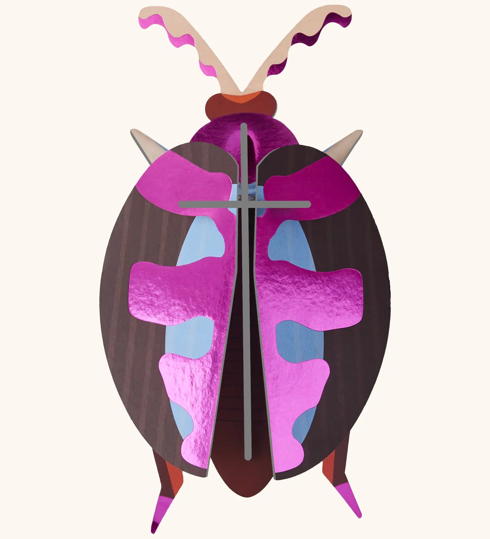 A Studio Roof 3D lumen pink beetle cardboard wall art fully assembled with a metallic finish on the pieces.