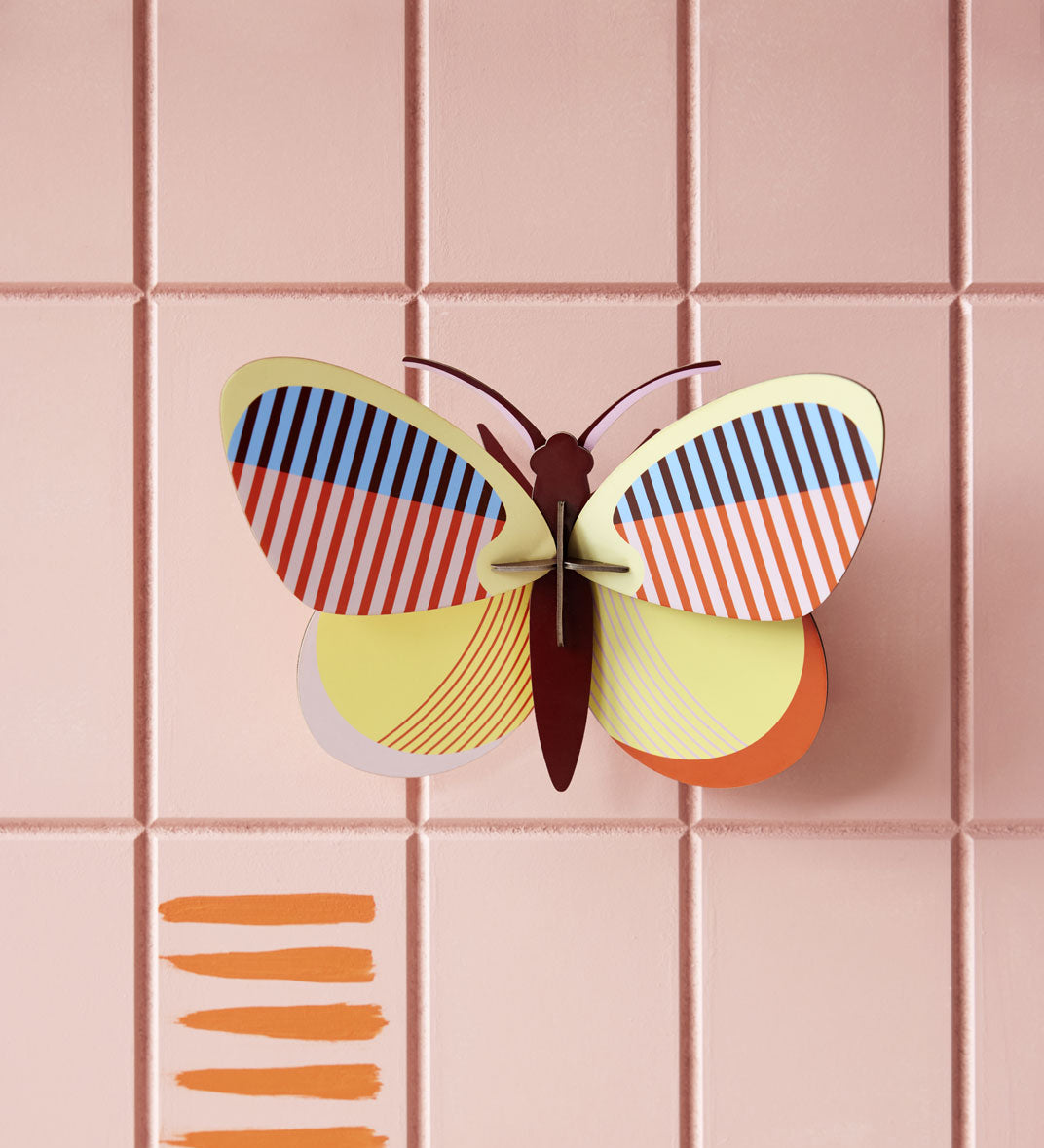 Studio Roof Medium Sia Butterfly pictured hung up on a pink paneled wall