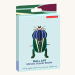 Studio Roof Mimela Scarab Beetle decoration in it's box pictured on a plain background