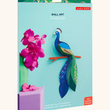 A Studio Roof 3D paradise peacock bird perched on a branch craft kit shown in it's packaging 