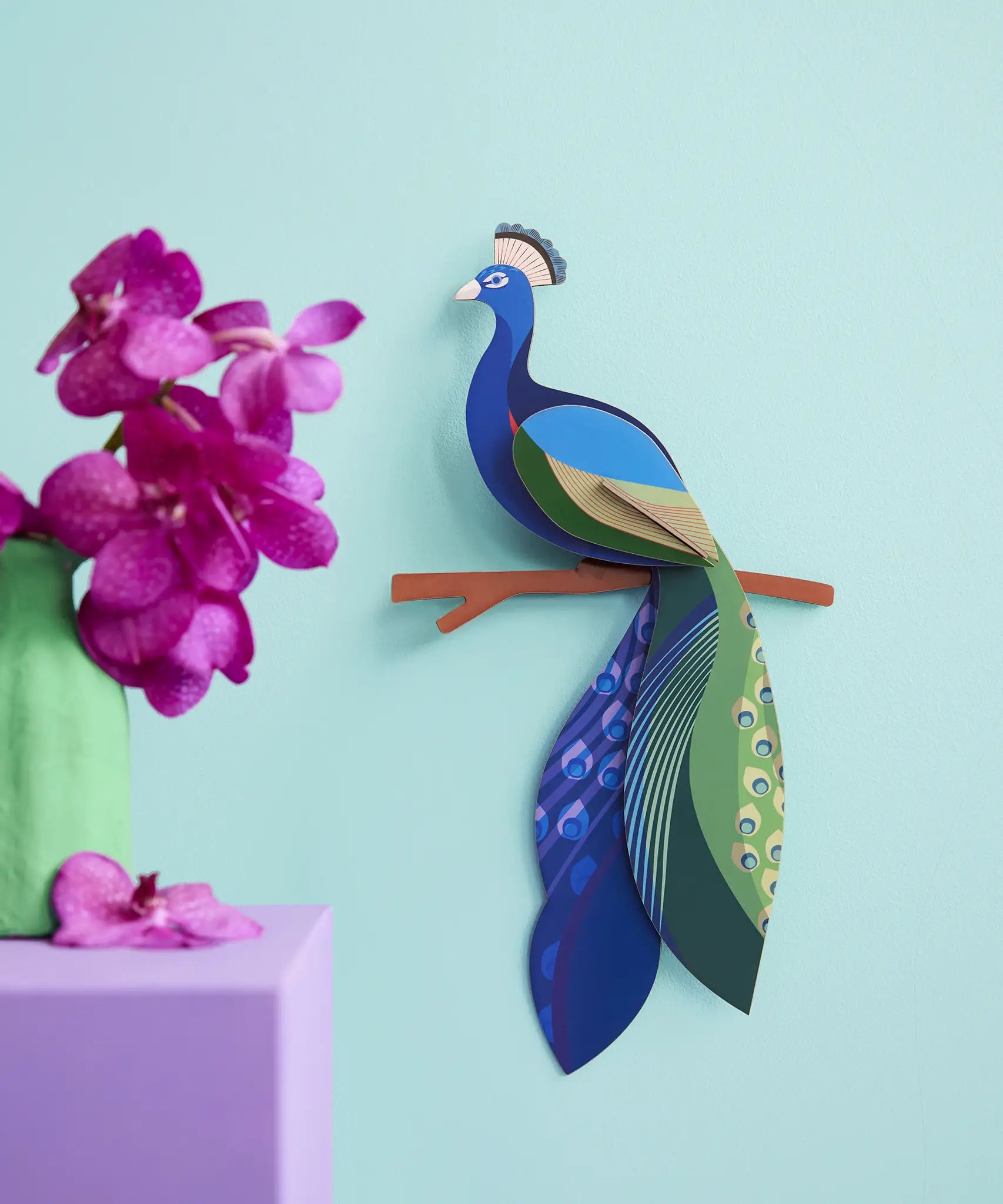 A Studio Roof 3D paradise peacock bird perched on a branch displayed on a wall