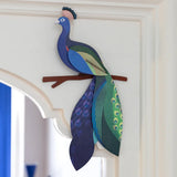 A Studio Roof 3D paradise peacock bird perched on a branch displayed on a window frame