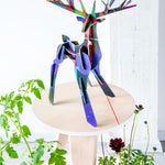 Studio roof totem stag slotting animal model stood on a wooden table above some green plants
