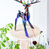 Studio roof totem stag slotting animal model stood on a wooden table above some green plants