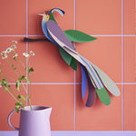Tinjil and Maya bird of Paradise together on a green tiled background