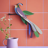 Tinjil and Maya bird of Paradise together on a green tiled background