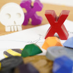 Close up of the crayon bug pirate treasure crayons laid out on a white book page
