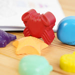 Close up of the Crayon Bug seaside crayons stood up on a wooden background