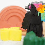 Close up of a black wax unicorn from the crayon bug unicorn dreams pack on a white background