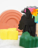 Close up of a black wax unicorn from the crayon bug unicorn dreams pack on a white background