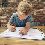 A child holding the The Phive Enchanting Learning Storywriter's Book - The Kingdom