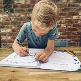A child holding the The Phive Enchanting Learning Storywriter's Book - The Kingdom