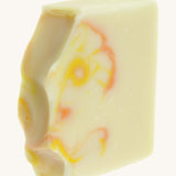 A close up of the The Soapmine heulwen/sunshine bar. A Handmade soap available at Babipur with Bergamot and Mandarin essential oils showing the hand cut detail 
