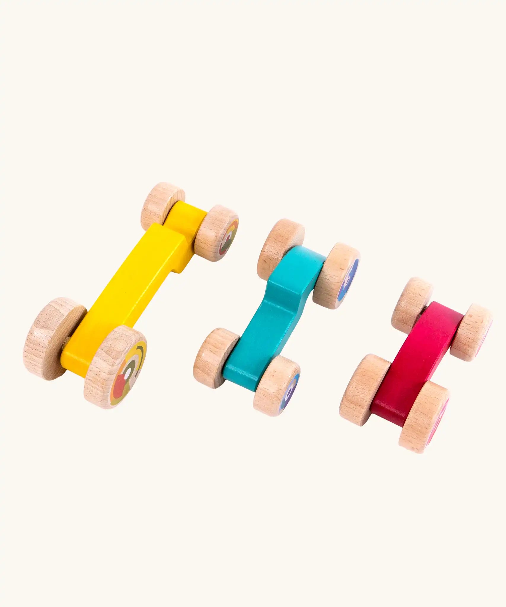 Tobe 3ple Stacking Cars wooden toys. Pink, blue and yellow coloured toy cars. View from above.