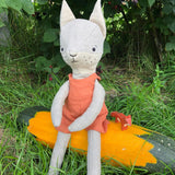 Close up of the Tobe hempions fox toy in a small tree surrounded by red berries