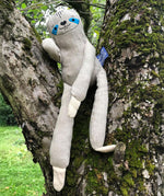 The Tobe The Hempions sloth toy placed on a tree. 