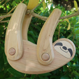 Tobe wooden Sloth toy figure with movable limbs. The sloth is pictured on a tree. These heirloom quality toys by Tobe are part of the Bajo family which have a wide range of wooden toys available here at Babipur. 