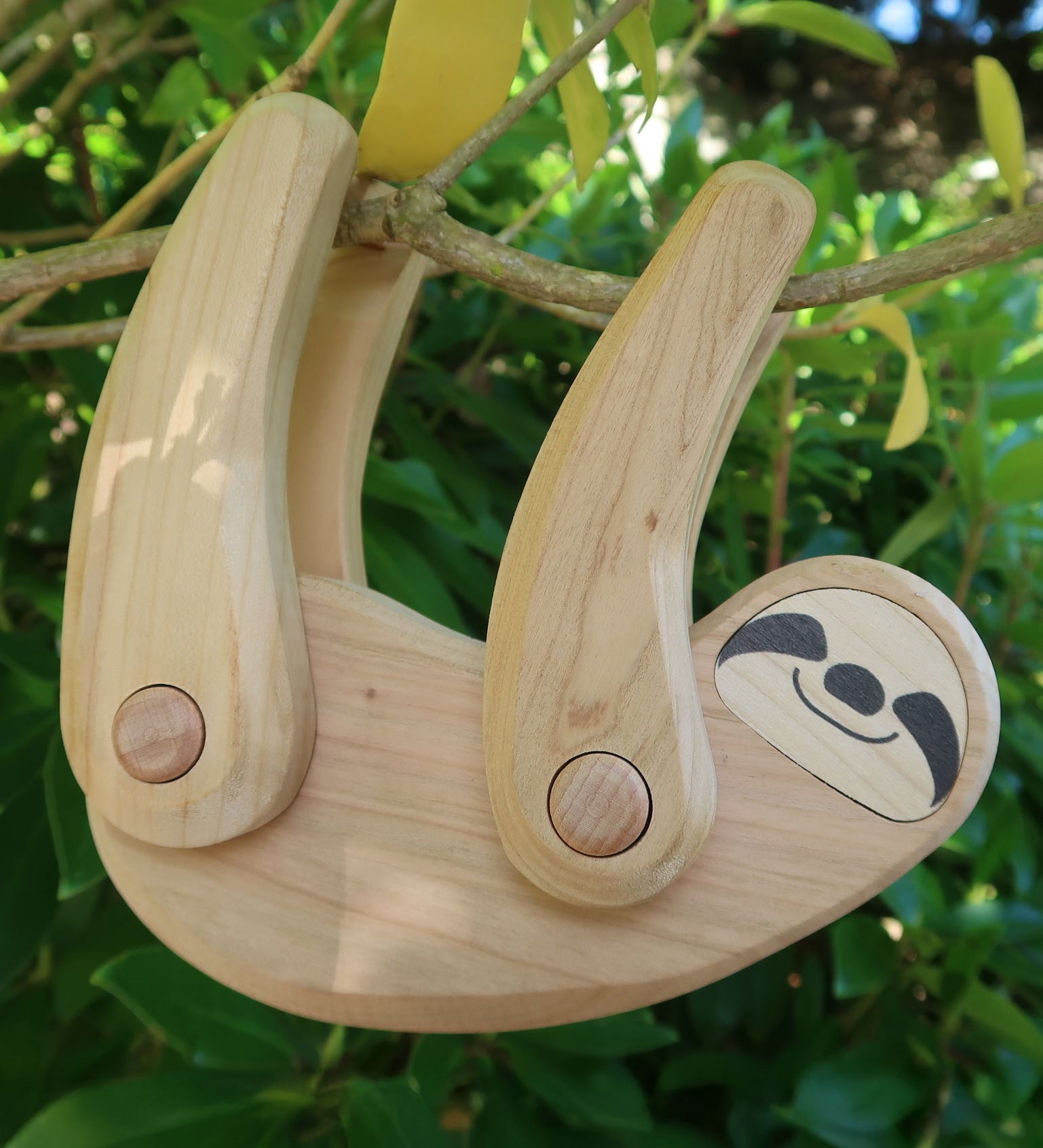 Tobe wooden Sloth toy figure with movable limbs. The sloth is pictured on a tree. These heirloom quality toys by Tobe are part of the Bajo family which have a wide range of wooden toys available here at Babipur. 