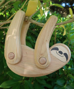 Tobe wooden Sloth toy figure with movable limbs. The sloth is pictured on a tree. These heirloom quality toys by Tobe are part of the Bajo family which have a wide range of wooden toys available here at Babipur. 