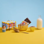 An open bar Tony's Chocolonely Fairtrade Milk Rice Crispy Caramel chocolate in a bowl of chocolate caramel covered crispies. 