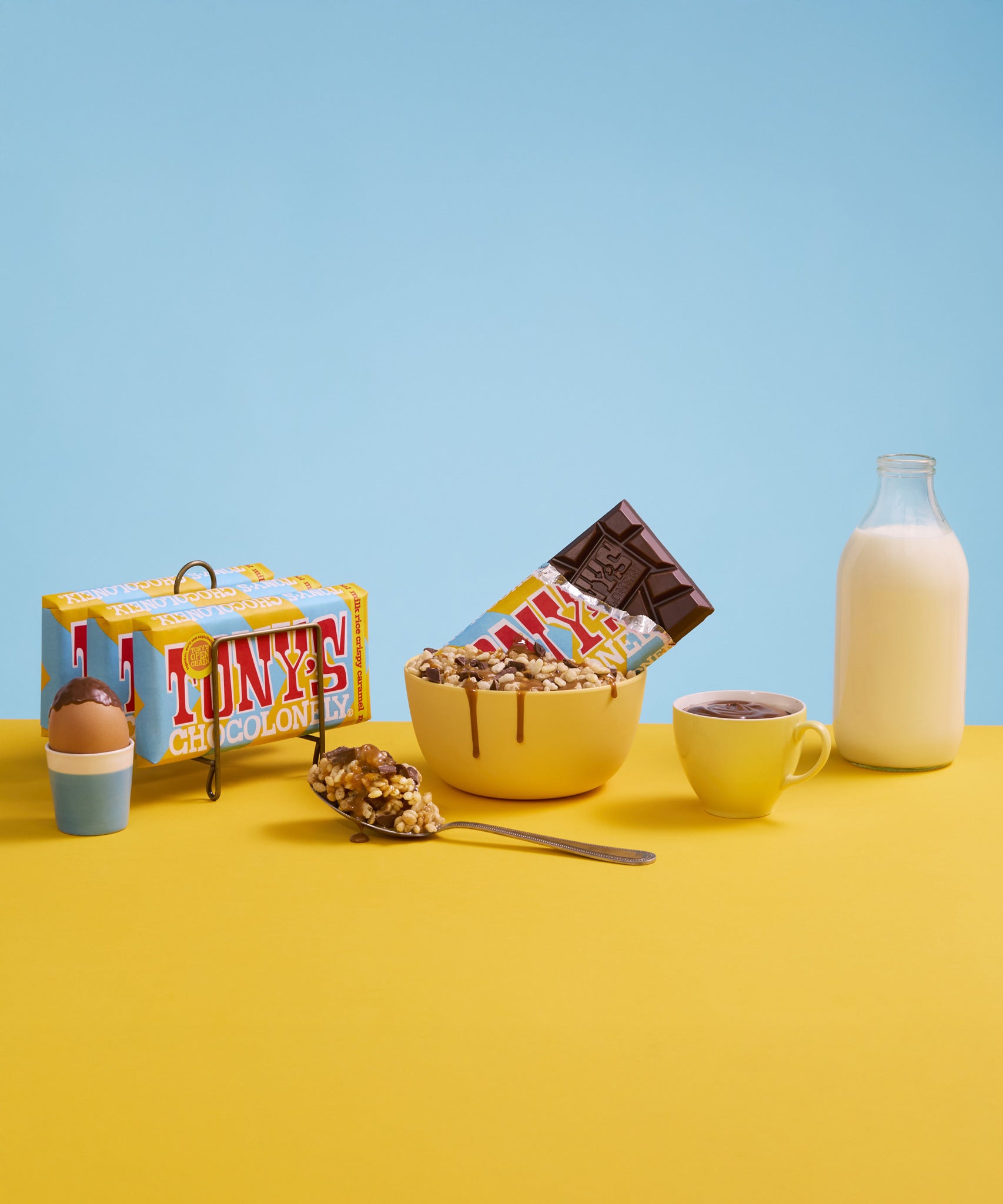 An open bar Tony's Chocolonely Fairtrade Milk Rice Crispy Caramel chocolate in a bowl of chocolate caramel covered crispies. 