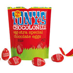 Tony's chocolonely fairtrade mini milk chocolate easter eggs share bag open on a white background next to some red chocolate eggs