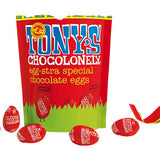 Tony's chocolonely fairtrade mini milk chocolate easter eggs share bag open on a white background next to some red chocolate eggs
