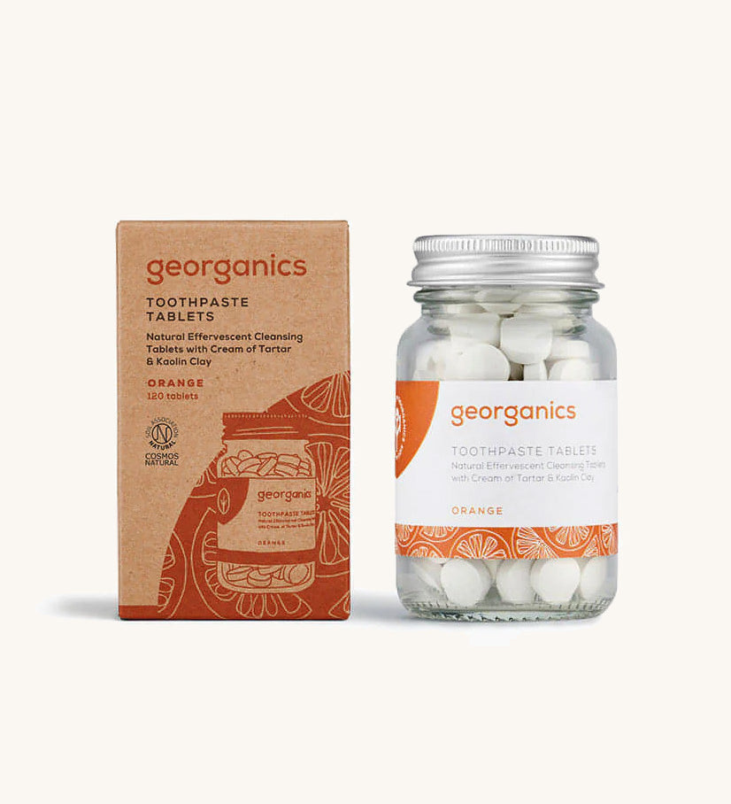 A jar of the Georganics orange toothpaste tablets with the box