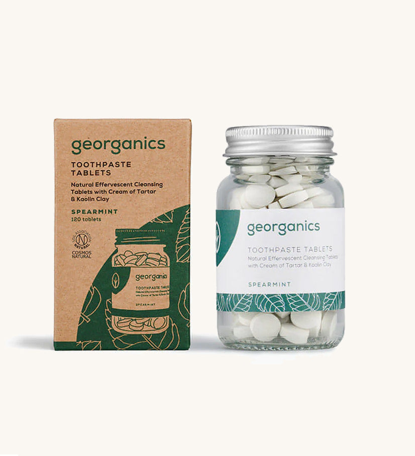 A jar of the Georganics spearmint toothpaste tablets with the box