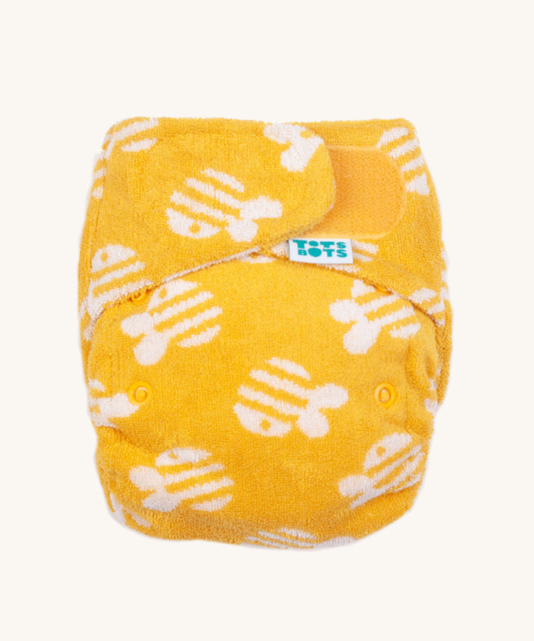Tots Bots Bamboozle Birth to Potty nappy in a yellow bumble print. 