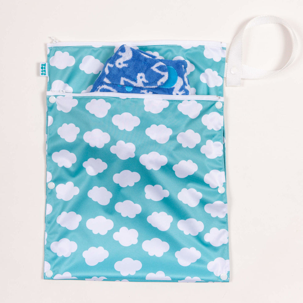 Tots Bots Wet andDry Bag in the Fluffy Clouds print with a bamboozle nappy in the front pocket