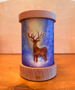 Toverlux lantern shade by Baukje Exler featuring translucent oil pastel artwork of quite early morning deer standing in a blue coloured forest backdrop. 