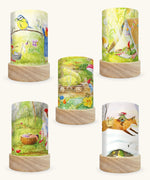 Set of 5 Toverlux Lantern Shades by Mhairi Hellbrandt pencil and paint artworks of gnome tales including 5 different seasonal illustrations on each. Spring gnomes with a blue tit,  Summer gnomes in a tent with a robin, September gnomes harvesting pears, Autumn gnomes mending clothes and Winter gnomes riding a fox in a snow covered forest.